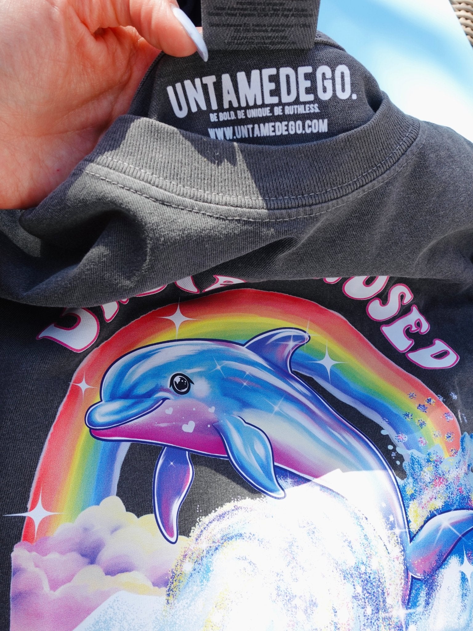 Funny graphic t-shirt with dolphin and rainbow design and text saying undiagnosed but everyone’s pretty sure
