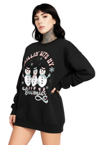 Person wearing a black sweatshirt with snowman graphic and text on a white background