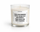 A white scented candle in a clear glass jar with a white label featuring black text that reads, 'UNTAMEDEGO WE'LL BE FRIENDS UNTIL WE'RE OLD AND SENILE. THEN WE'LL BE NEW FRIENDS.