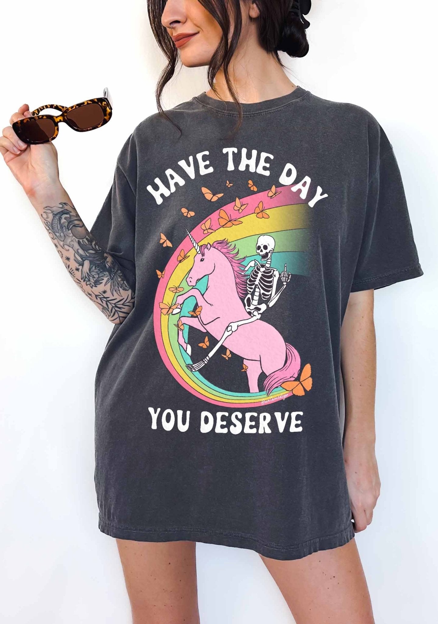 Funny sarcastic t-shirt with unicorn and skeleton design and text saying have the day you deserve