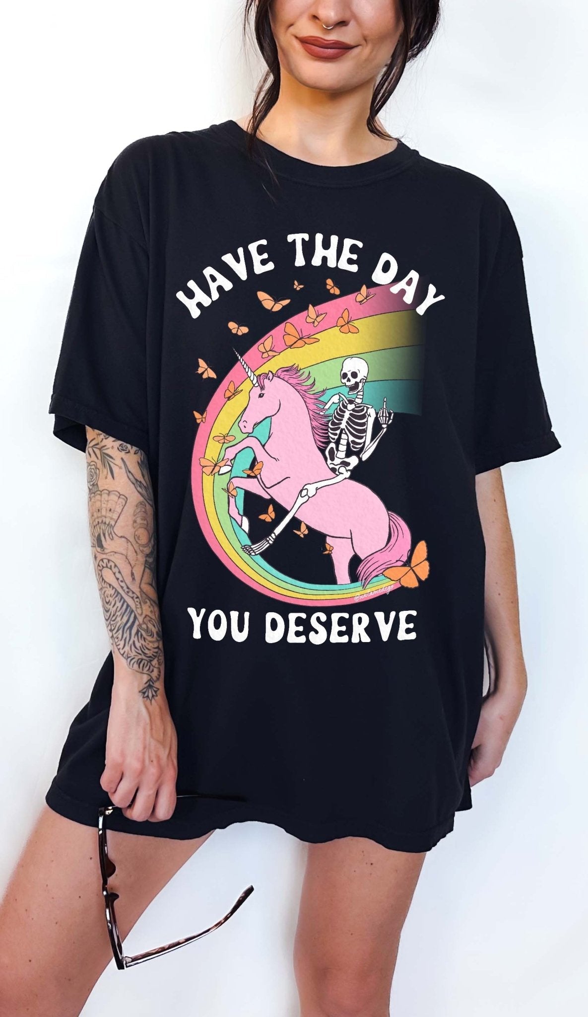 Funny sarcastic t-shirt with unicorn and skeleton design and text saying have the day you deserve