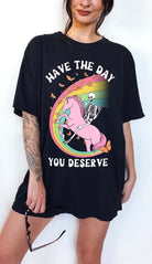 Funny sarcastic t-shirt with unicorn and skeleton design and text saying have the day you deserve