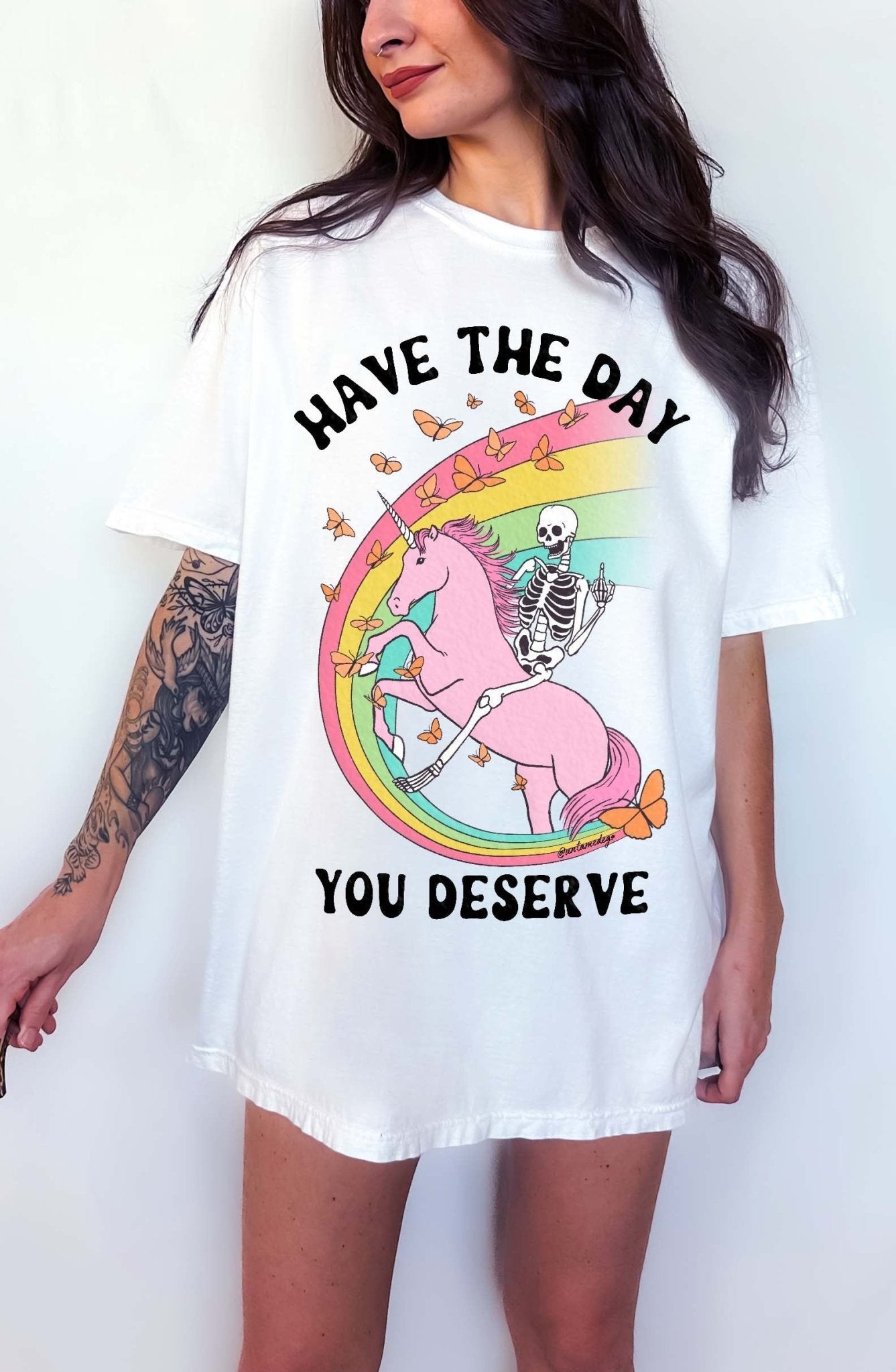 Funny sarcastic t-shirt with unicorn and skeleton design and text saying have the day you deserve