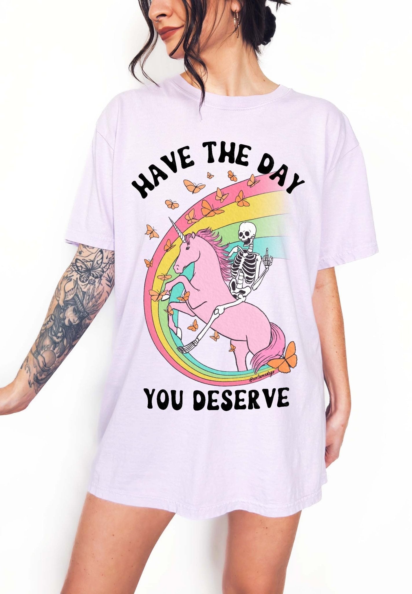 Funny sarcastic t-shirt with unicorn and skeleton design and text saying have the day you deserve