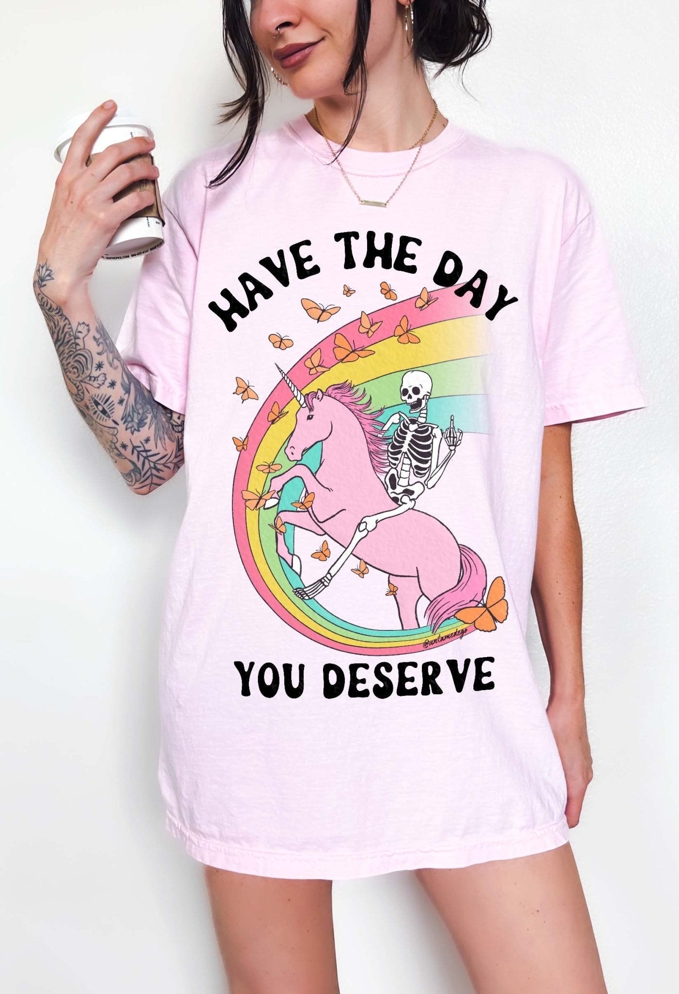 Funny sarcastic t-shirt with unicorn and skeleton design and text saying have the day you deserve